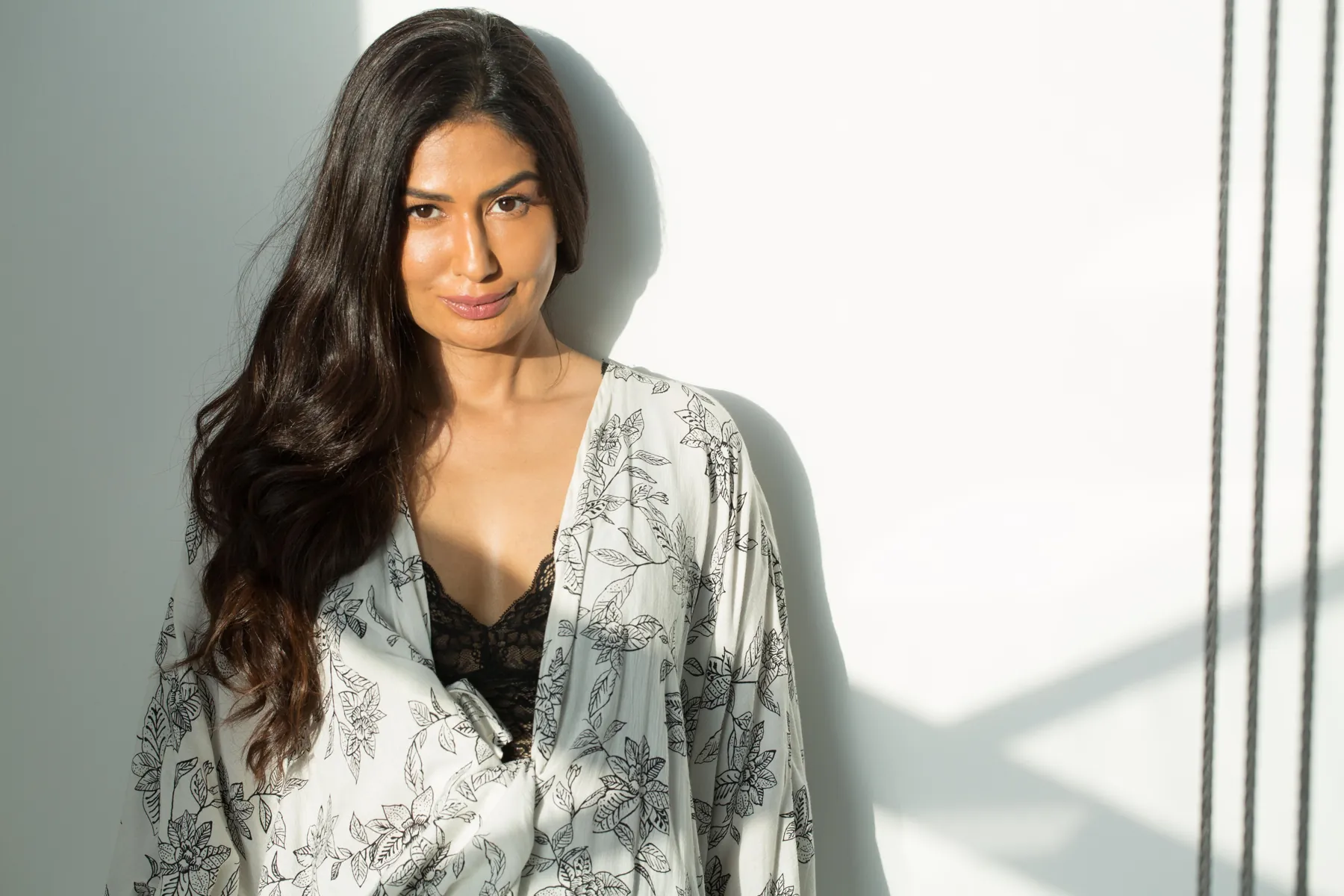 Uma Ghosh in soft window light, looking at the camera