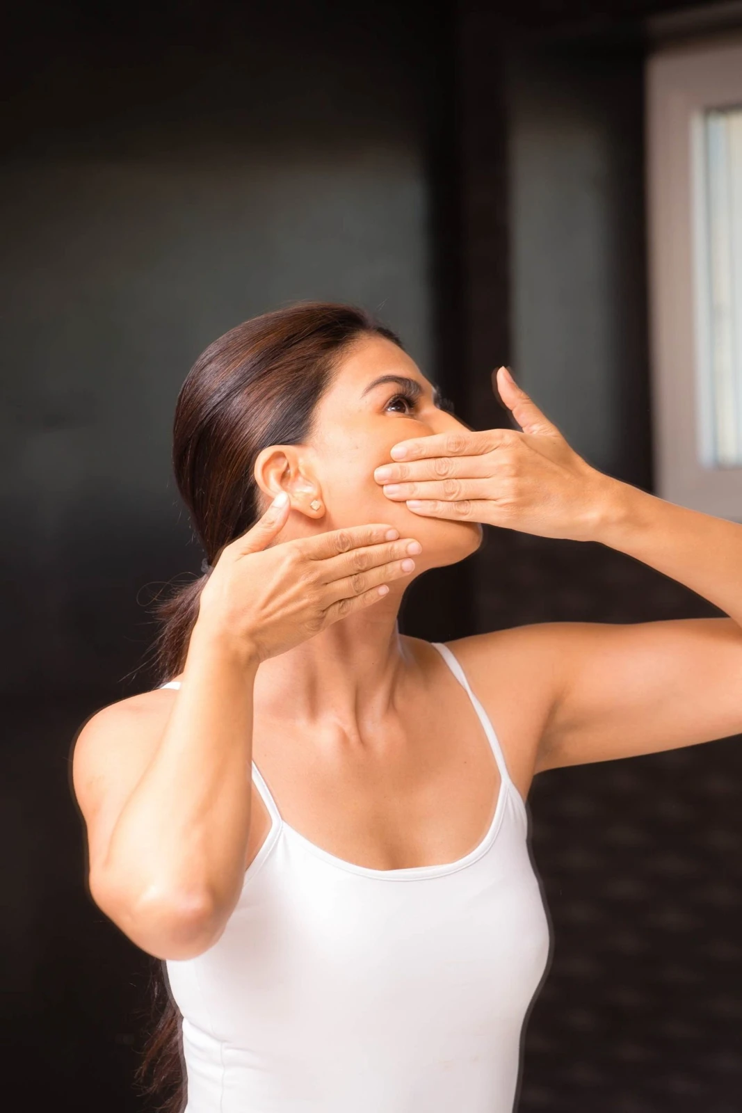 Uma working with her face through gentle hands-on massage