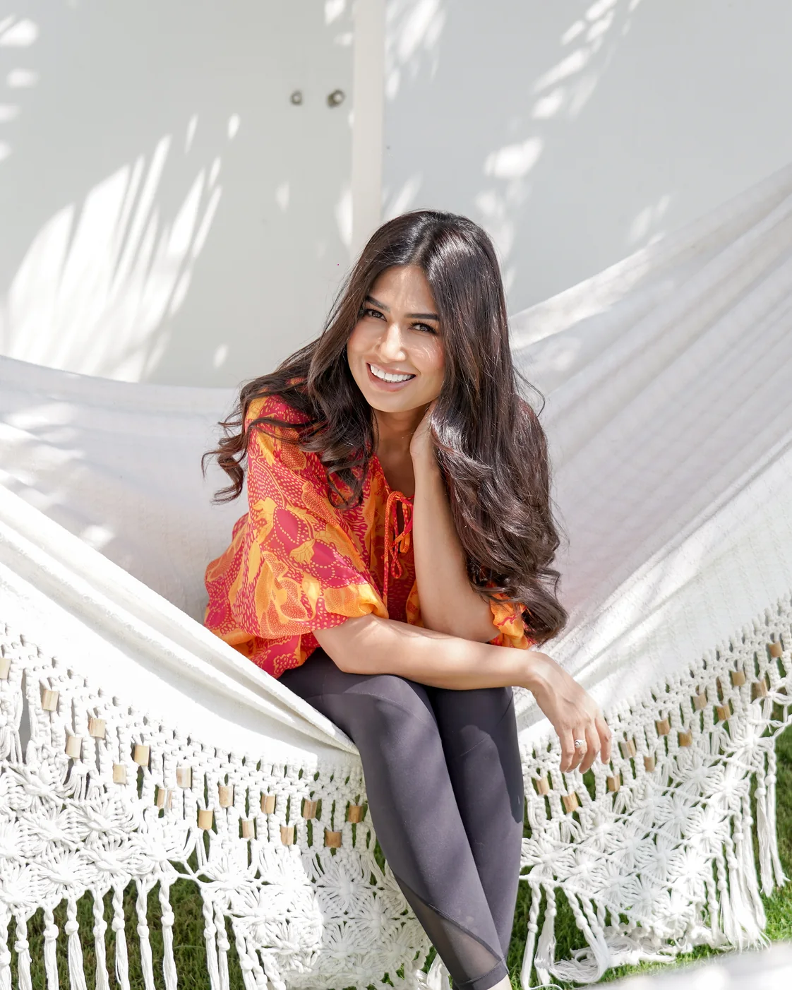 Uma Ghosh sitting in a hammock in the garden