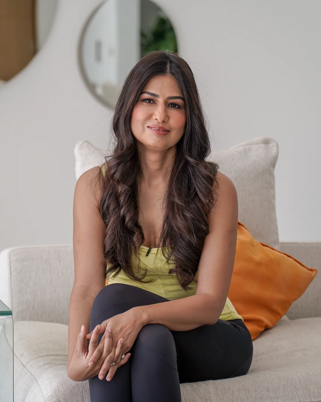 Uma Ghosh smiling in her living room