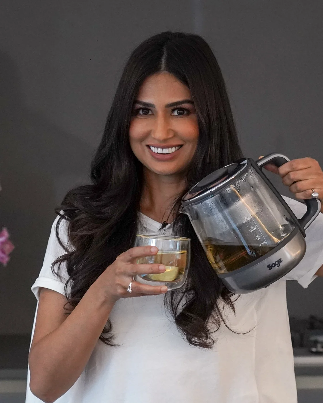 Uma Ghosh pouring herbal tea in her kitchen