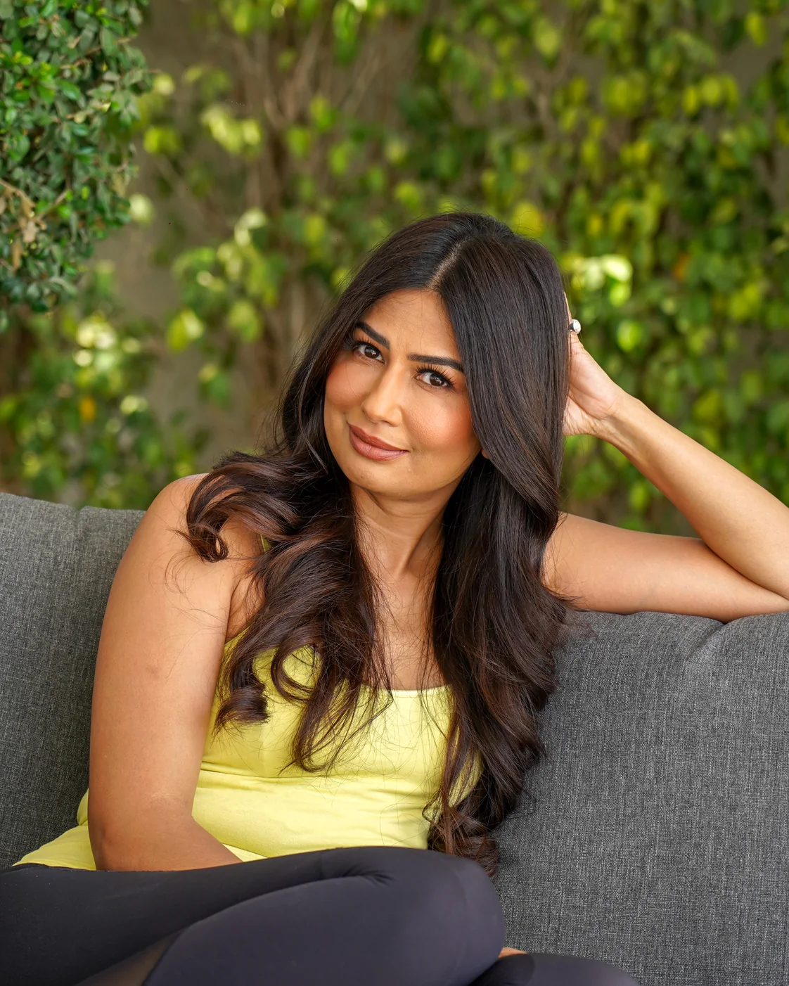 Uma Ghosh seated on a garden sofa