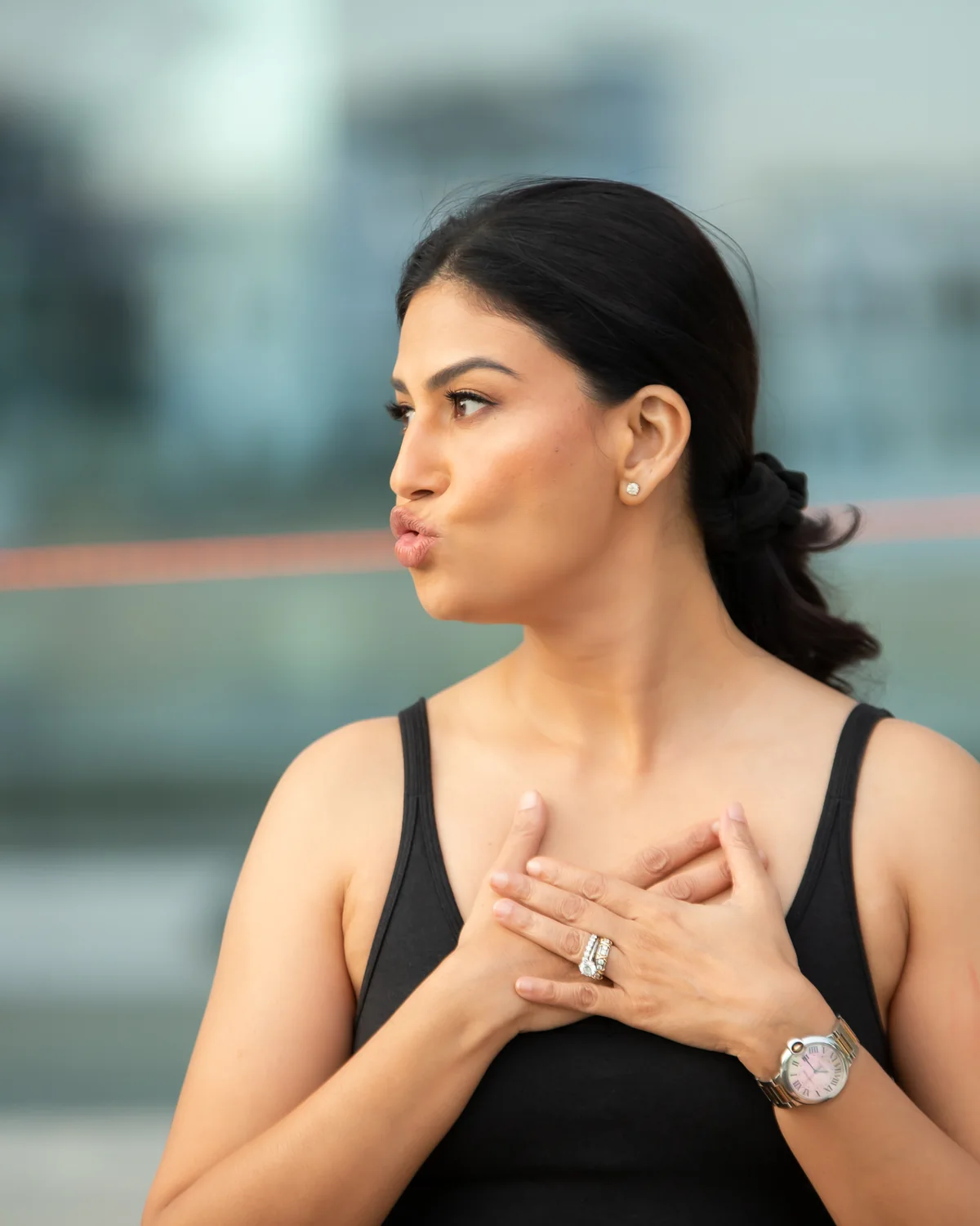 Uma demonstrating self-massage across her chest and décolleté