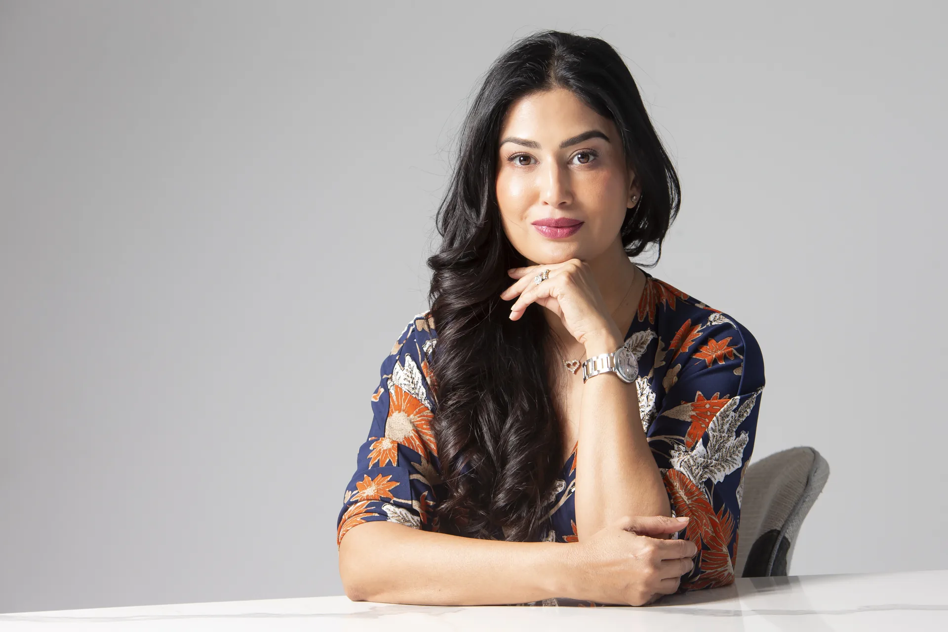 Uma Ghosh seated at a table, calm and at ease