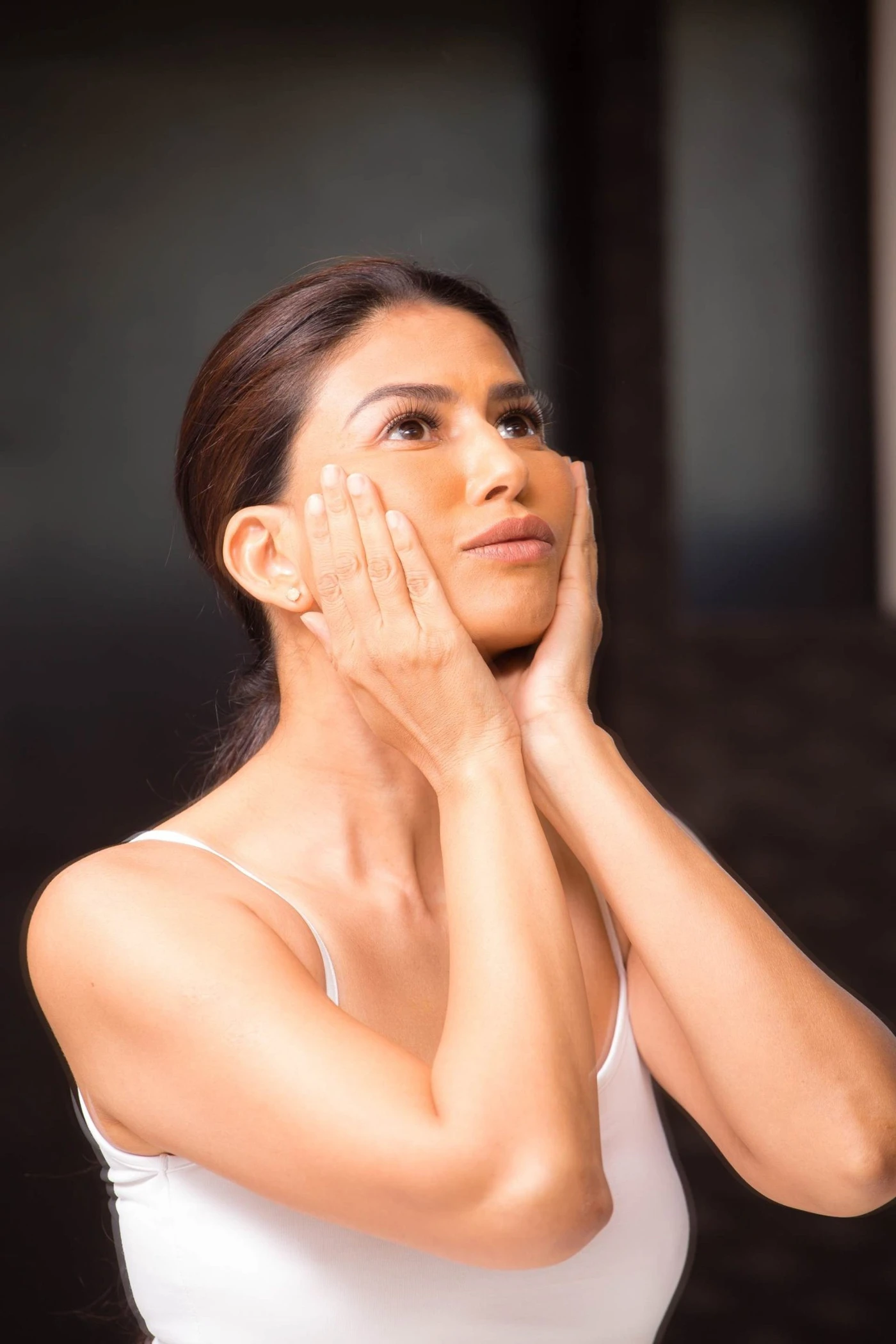 Uma using mindful touch along her cheeks
