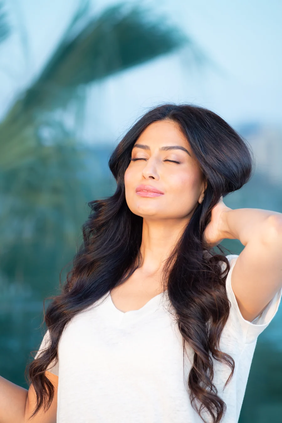 Uma pausing outdoors in natural light