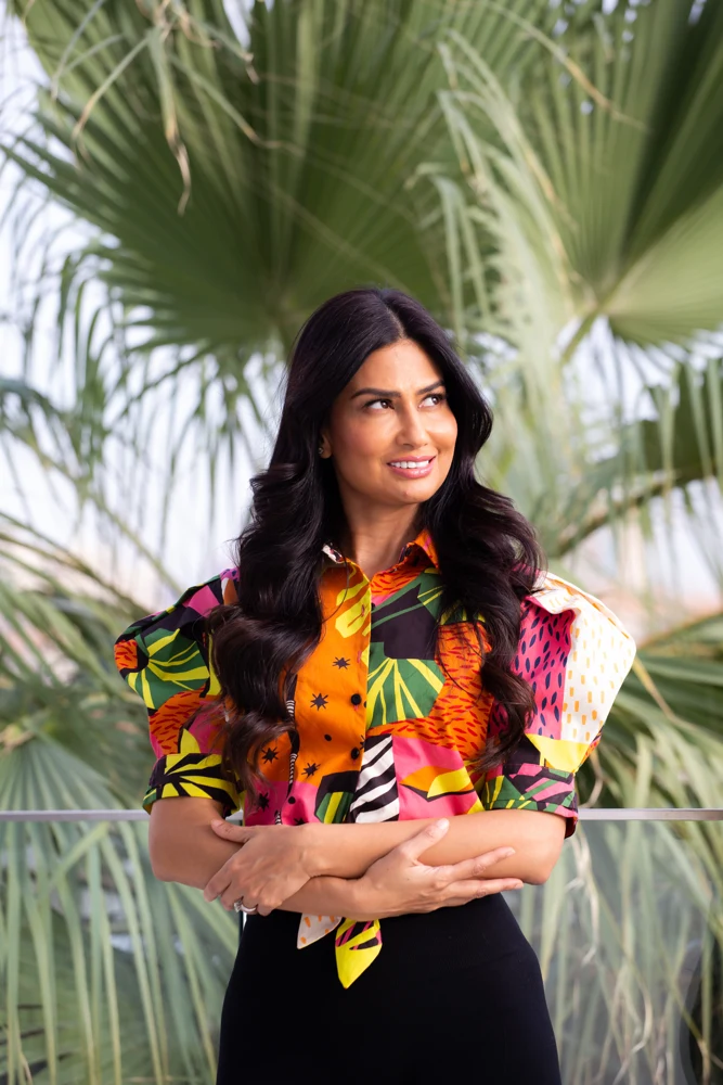 Uma outdoors beneath palm leaves