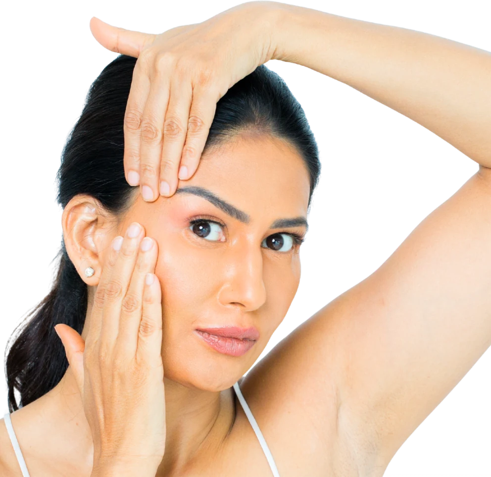 Uma practising a face massage movement, one hand drawing along her cheek and the other resting across her brow
